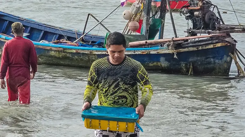 Samui fisherman with his catch